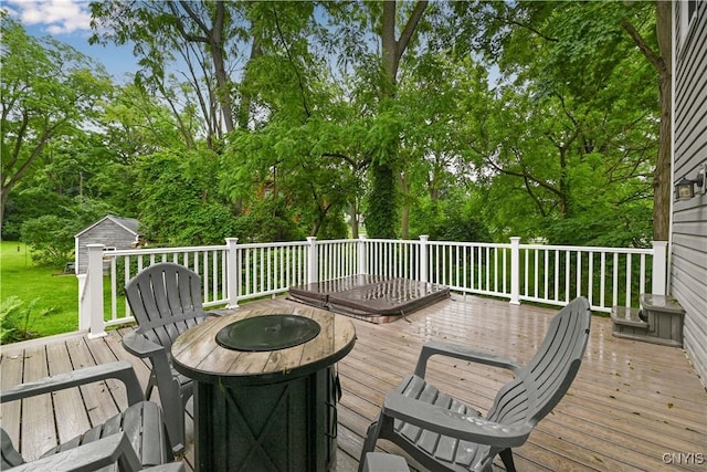 6188 Lake St, Aurelius, NY 13034 - wooden terrace with a fire pit, a storage shed, and view of wooded area