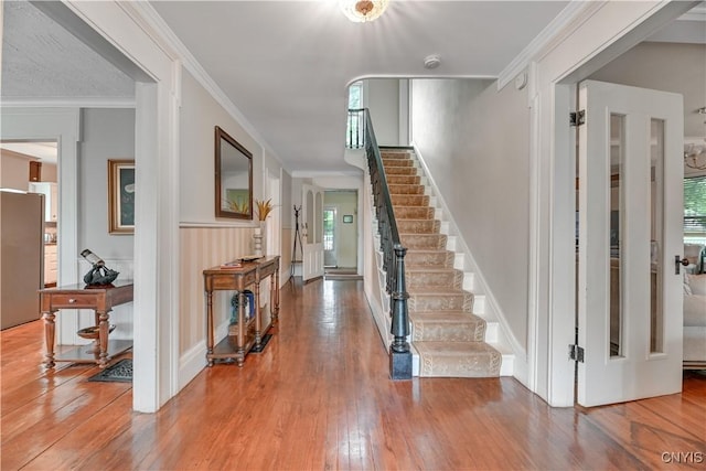 6188 Lake St, Aurelius, NY 13034 - foyer featuring hardwood / wood-style flooring, stairway, healthy amount of natural light, and ornamental molding