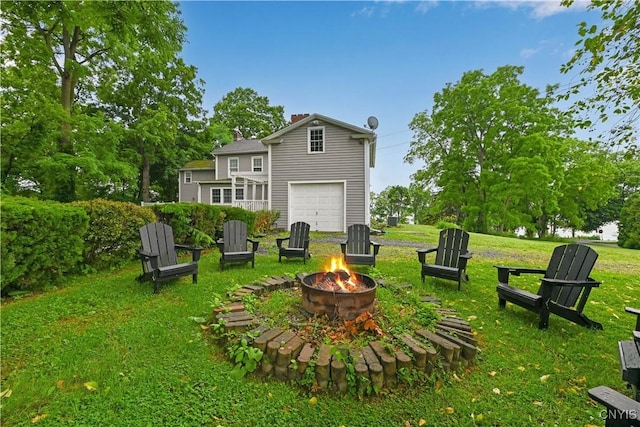 6188 Lake St, Aurelius, NY 13034 - rear view of property featuring a fire pit, a chimney, a garage, and a lawn