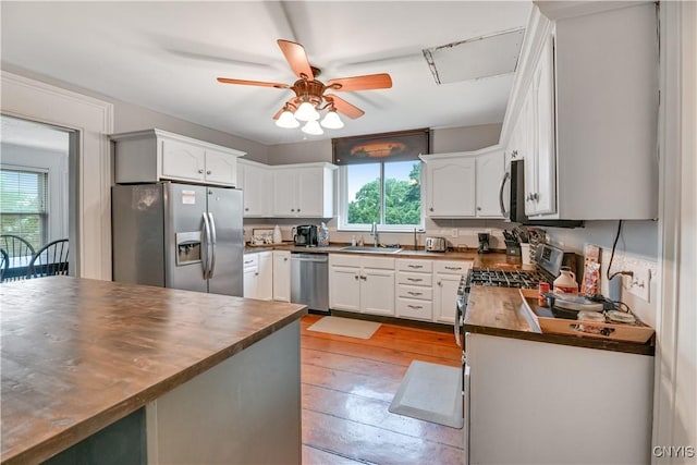 6188 Lake St, Aurelius, NY 13034 - kitchen with stainless steel appliances, wood counters, a ceiling fan, light wood finished floors, and white cabinets
