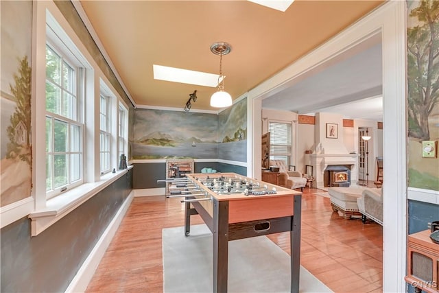 6188 Lake St, Aurelius, NY 13034 - rec room with a lit fireplace, wallpapered walls, ornamental molding, and wood finished floors