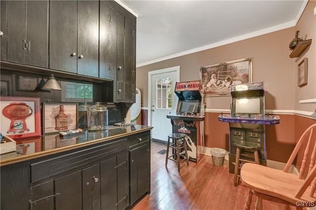 6188 Lake St, Aurelius, NY 13034 - kitchen featuring wood finished floors, ornamental molding, and dark cabinetry
