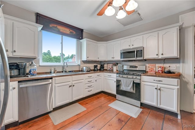 6188 Lake St, Aurelius, NY 13034 - kitchen featuring appliances with stainless steel finishes, white cabinetry, and light wood-style flooring