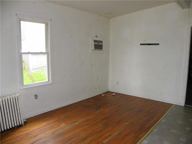 202-204-206 N Monroe St, Reading, NY 14891 - spare room featuring radiator heating unit, wood finished floors, and a wall mounted AC