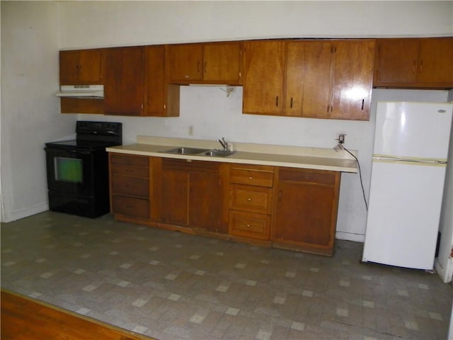 202-204-206 N Monroe St, Reading, NY 14891 - kitchen with freestanding refrigerator, electric range, under cabinet range hood, brown cabinetry, and light countertops