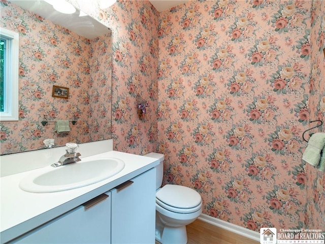 29 Elm Ln Unit 24, Chautauqua, NY 14722 - half bathroom featuring vanity, wood finished floors, and wallpapered walls