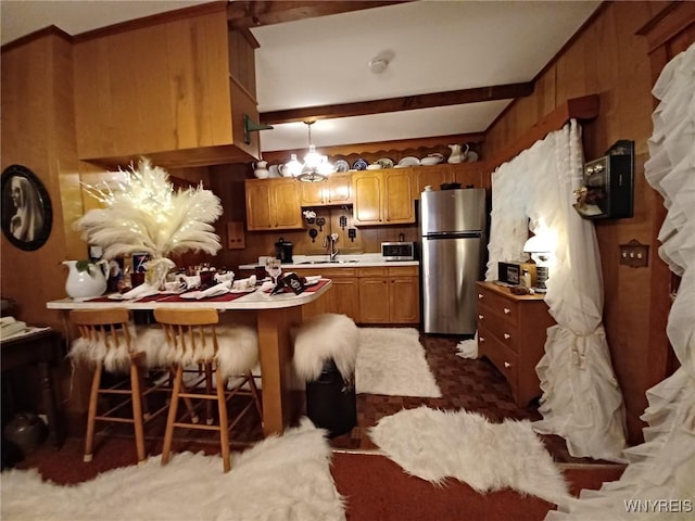 41 N Franklin St, New Albion, NY 14719 - kitchen featuring stainless steel appliances, a peninsula, a chandelier, light countertops, and beamed ceiling