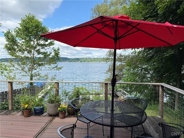 2487 E Lake Rd, Spafford, NY 13152 - wooden deck featuring a water view and outdoor dining area