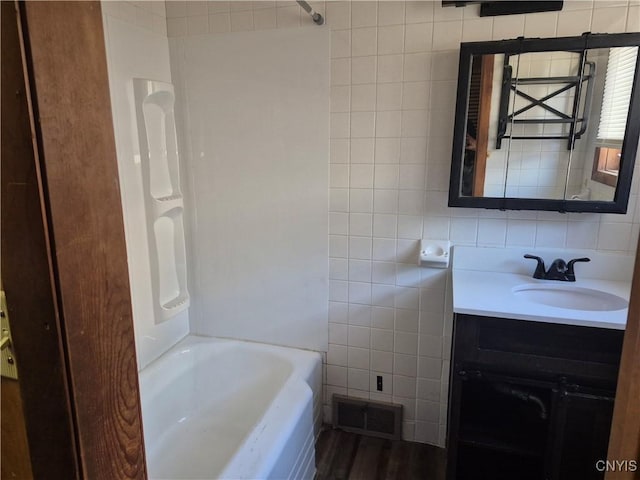 313 W 3rd St S, Fulton, NY 13069 - full bathroom featuring tile walls, vanity, and shower / tub combination