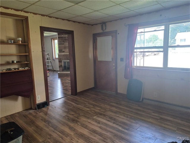 313 W 3rd St S, Fulton, NY 13069 - interior space featuring a drop ceiling, dark wood finished floors, plenty of natural light, and a fireplace