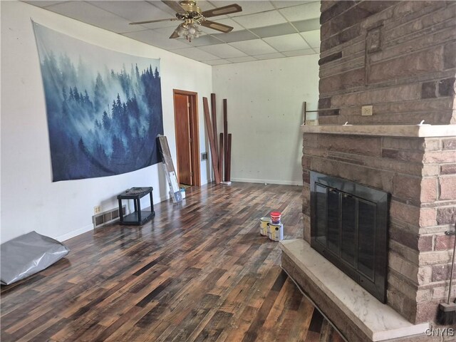 313 W 3rd St S, Fulton, NY 13069 - living room featuring a paneled ceiling, wood finished floors, ceiling fan, and a fireplace