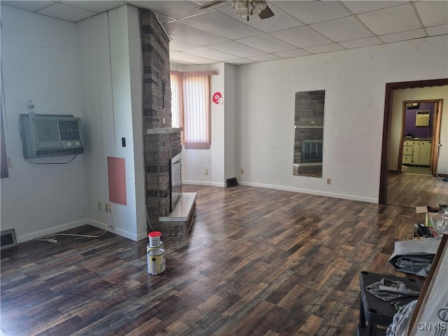 313 W 3rd St S, Fulton, NY 13069 - living area featuring a drop ceiling, a fireplace, wood finished floors, a wall mounted AC, and ceiling fan