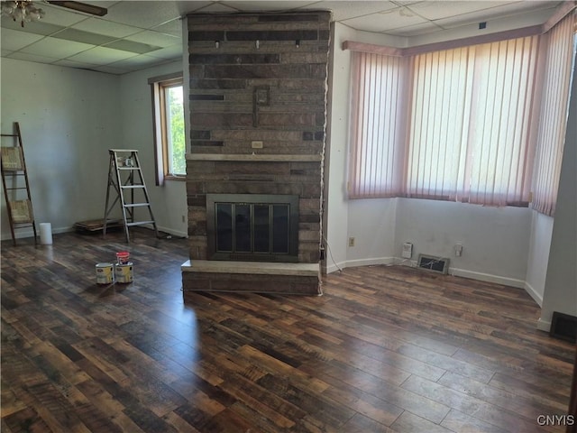 313 W 3rd St S, Fulton, NY 13069 - unfurnished living room with a drop ceiling, hardwood / wood-style flooring, and a fireplace