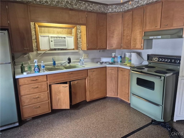 313 W 3rd St S, Fulton, NY 13069 - kitchen featuring under cabinet range hood, electric stove, freestanding refrigerator, light countertops, and brown cabinets