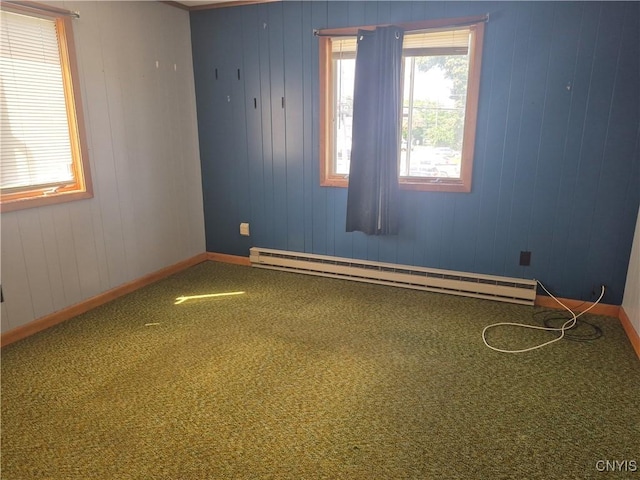 313 W 3rd St S, Fulton, NY 13069 - unfurnished room featuring a baseboard heating unit, carpet, and wood walls