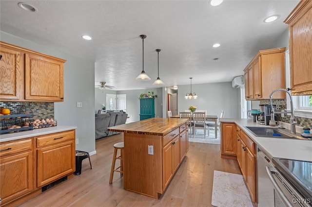 13489 Case Rd, Lyme, NY 13622 - kitchen featuring stainless steel appliances, decorative backsplash, open floor plan, a breakfast bar, and light wood-style flooring