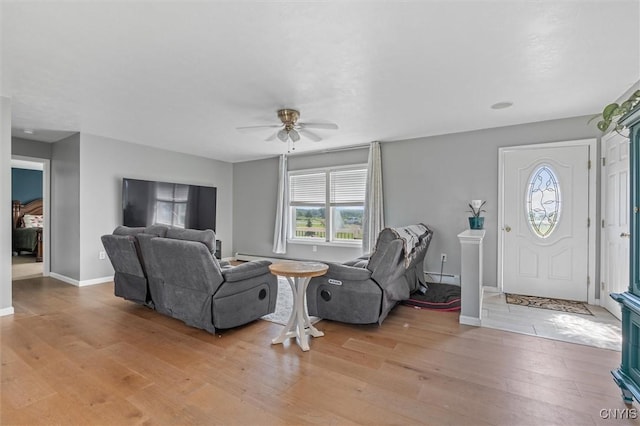 13489 Case Rd, Lyme, NY 13622 - living area with light wood finished floors, ceiling fan, and a baseboard radiator