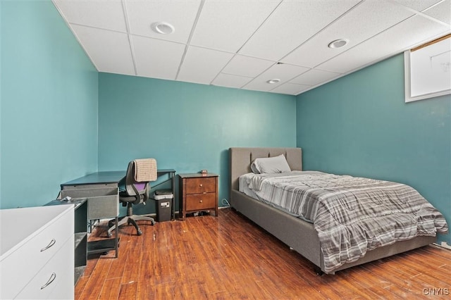 13489 Case Rd, Lyme, NY 13622 - bedroom featuring wood finished floors, a drop ceiling, and a desk
