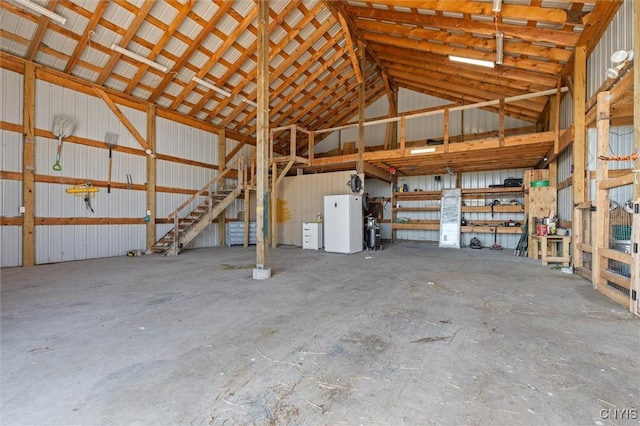 13489 Case Rd, Lyme, NY 13622 - garage featuring freestanding refrigerator and metal wall