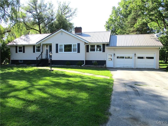 7739 Roberts St, Lenox, NY 13032 - view of front of house with a chimney, a garage, asphalt driveway, a metal roof, and a front yard