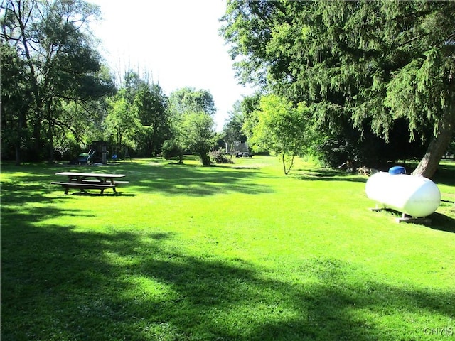 7739 Roberts St, Lenox, NY 13032 - surrounding community with a yard and view of wooded area