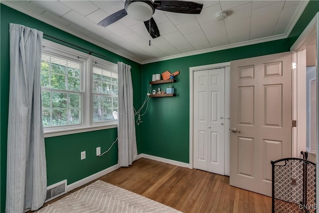 266 Chestnut St, Watertown City, NY 13601 - unfurnished bedroom featuring crown molding, wood finished floors, a closet, and ceiling fan