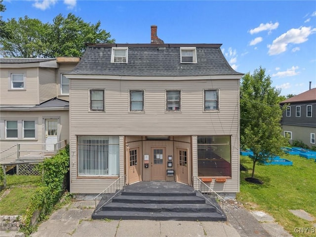 116 W Manlius St, Dewitt, NY 13057 - view of front of home with roof with shingles, mansard roof, and a front yard