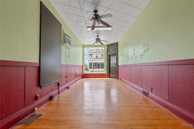 116 W Manlius St, Dewitt, NY 13057 - empty room with wood finished floors, ceiling fan, and a wainscoted wall