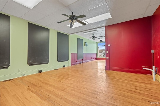116 W Manlius St, Dewitt, NY 13057 - empty room with wood finished floors, ceiling fan, and a paneled ceiling