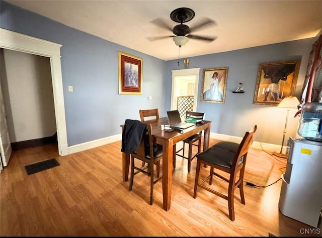 176-178 E Clark St, German Flatts, NY 13357 - dining space with a ceiling fan, light wood-type flooring, and a desk