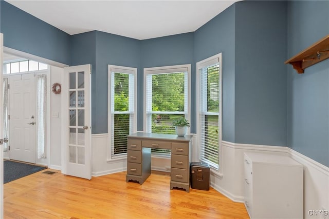 8879 Kilkenny Dr, Lysander, NY 13027 - unfurnished office featuring light wood-style flooring, healthy amount of natural light, and wainscoting
