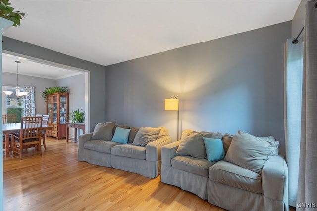8879 Kilkenny Dr, Lysander, NY 13027 - living room with a chandelier and light wood-type flooring