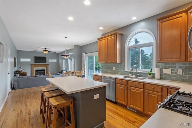 8879 Kilkenny Dr, Lysander, NY 13027 - kitchen with stainless steel dishwasher, open floor plan, a ceiling fan, light wood-style flooring, and light countertops