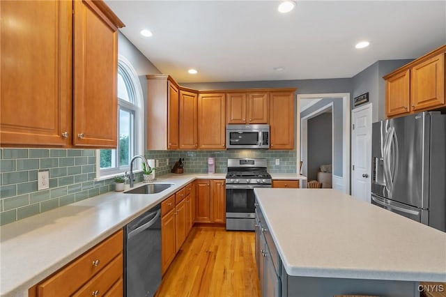 8879 Kilkenny Dr, Lysander, NY 13027 - kitchen featuring stainless steel appliances, light wood-style flooring, light countertops, recessed lighting, and a kitchen island