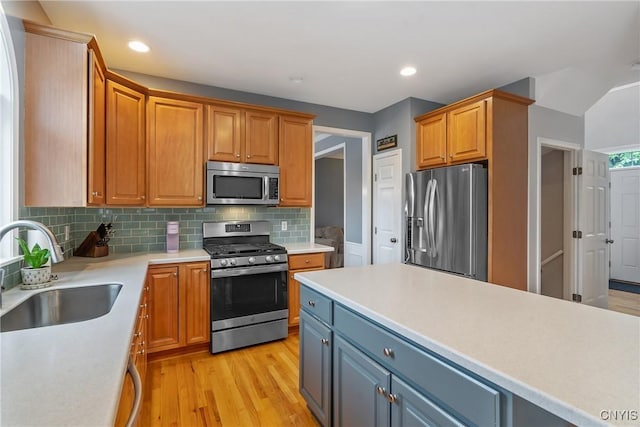 8879 Kilkenny Dr, Lysander, NY 13027 - kitchen with stainless steel appliances, light wood-type flooring, light countertops, tasteful backsplash, and recessed lighting