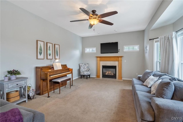 8879 Kilkenny Dr, Lysander, NY 13027 - living room featuring a fireplace with flush hearth, ceiling fan, and light colored carpet