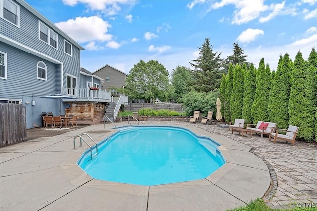 8879 Kilkenny Dr, Lysander, NY 13027 - view of pool with a patio, stairway, a fenced backyard, and outdoor dining space