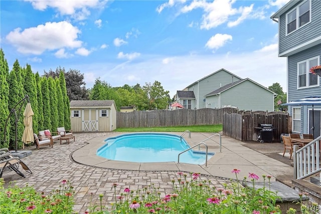 8879 Kilkenny Dr, Lysander, NY 13027 - view of swimming pool with a patio area, a storage unit, a fenced backyard, and grilling area