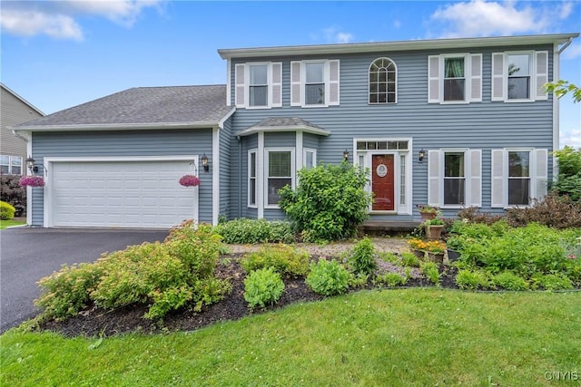 8879 Kilkenny Dr, Lysander, NY 13027 - view of front of home with a garage, driveway, and a front lawn
