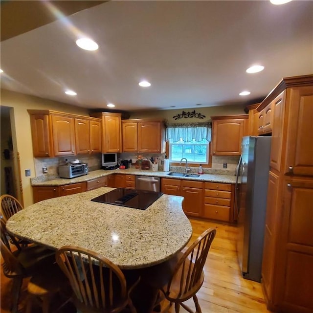 56 Briarcliff, Horseheads, NY 14845 - kitchen featuring stainless steel appliances, a breakfast bar, light wood-style floors, recessed lighting, and light stone counters