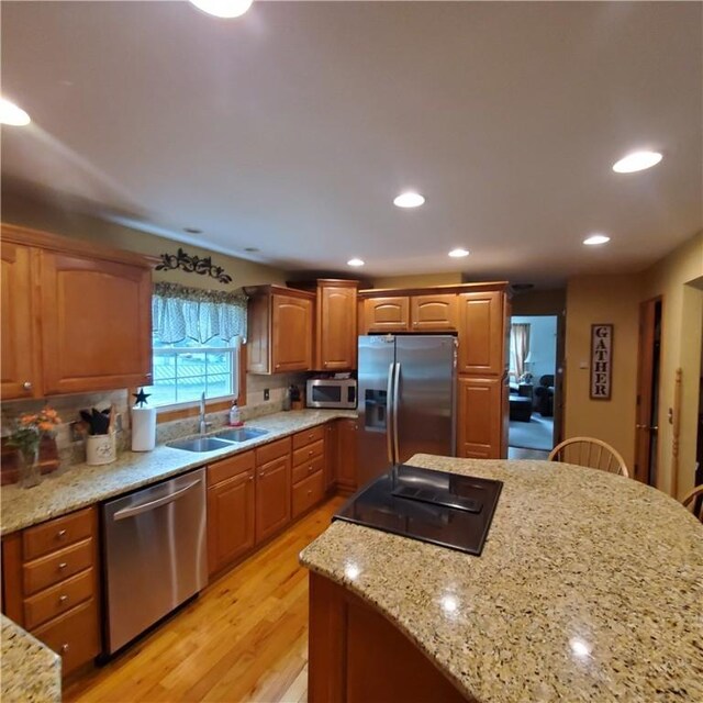 56 Briarcliff, Horseheads, NY 14845 - kitchen featuring stainless steel appliances, light wood finished floors, light stone countertops, recessed lighting, and decorative backsplash