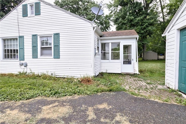 5978 State Route 21st Hwy, Williamson, NY 14589 - view of side of home featuring a sunroom and roof with shingles