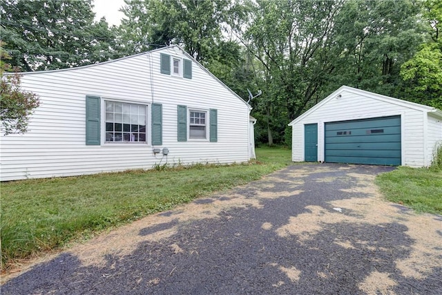 5978 State Route 21st Hwy, Williamson, NY 14589 - view of front facade featuring an outbuilding, a garage, driveway, and view of wooded area
