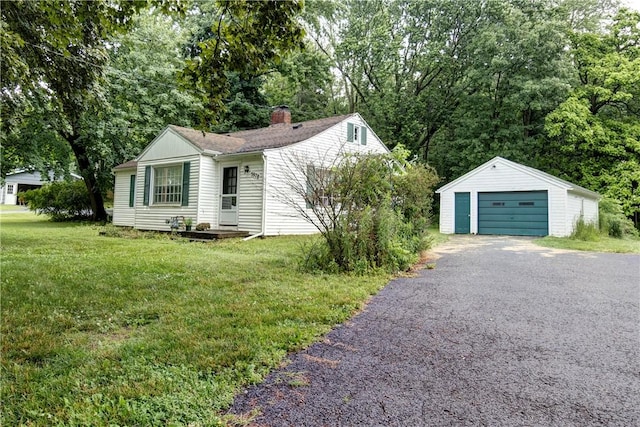 5978 State Route 21st Hwy, Williamson, NY 14589 - view of front of house with a garage, an outbuilding, a chimney, a front lawn, and driveway