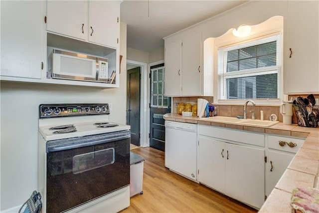 5978 State Route 21st Hwy, Williamson, NY 14589 - kitchen with white appliances, white cabinets, light wood-type flooring, backsplash, and tile counters