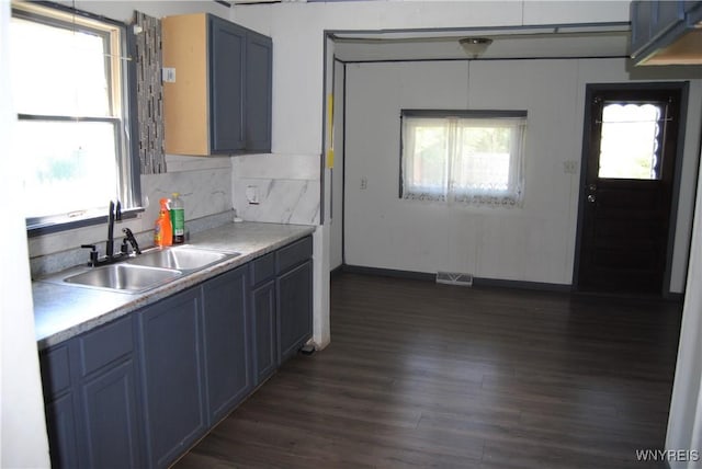 3028 Welch Ave, Niagara Falls, NY 14303 - kitchen featuring dark wood-style floors, light countertops, blue cabinetry, and decorative backsplash