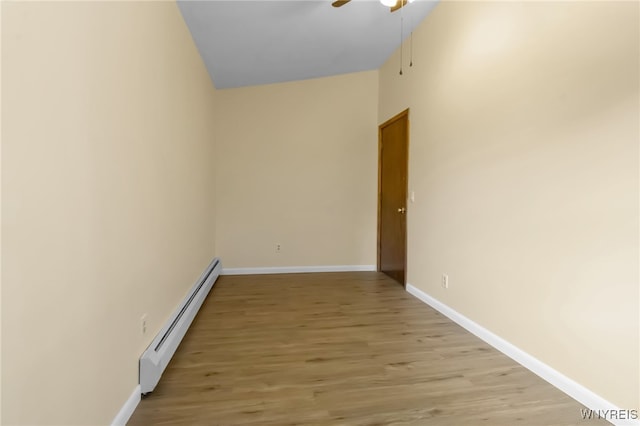 2035 Centerline Rd, Sheldon, NY 14167 - spare room with a baseboard radiator, ceiling fan, and light wood-style flooring