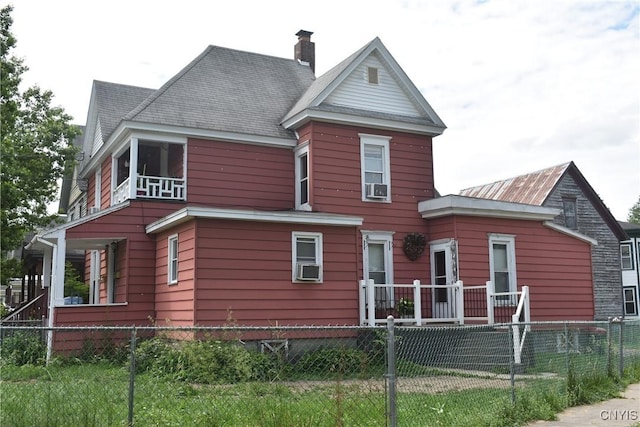 20 E Main St, Cortland, NY 13045 - view of front facade with a fenced front yard, cooling unit, and a chimney