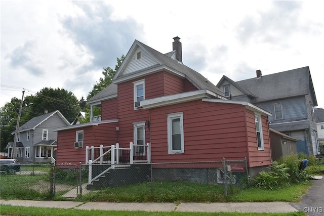 20 E Main St, Cortland, NY 13045 - view of side of home with a fenced front yard, a gate, and a chimney