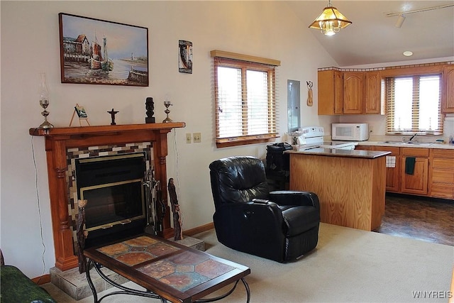 5436 Java Lake Rd, Java, NY 14009 - kitchen with white microwave, range, vaulted ceiling, brown cabinetry, and decorative light fixtures